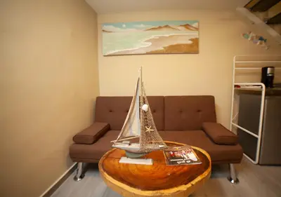a living room with a table with a toy boat on it at JEYMAR STUDIO rd in Santo Domingo