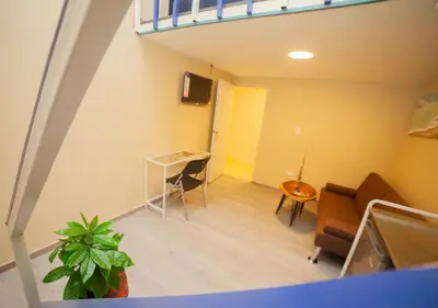 a view of a living room with a table and chairs at JEYMAR STUDIO rd in Santo Domingo