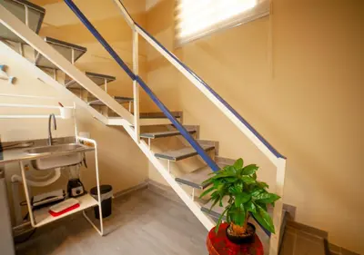a staircase in a room with a sink and a plant at JEYMAR STUDIO rd in Santo Domingo