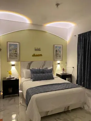 a bedroom with a large bed and two lamps at Little Room Airport By Merengue House in Monte Adentro