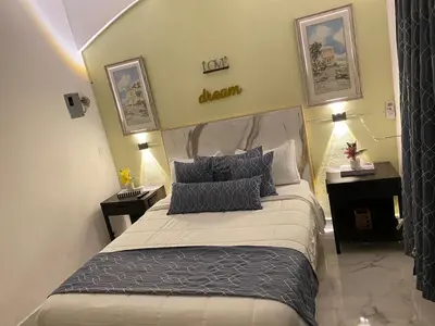 a bedroom with a bed with two nightstands and a bed sidx sidx sidx at Little Room Airport By Merengue House in Monte Adentro