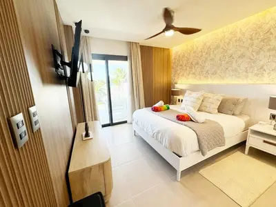 a bedroom with a bed and a television in it at Luxury penthouse with panoramic ocean view in Punta Cana