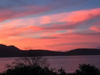 a sunset over a large body of water at The Cottage at Javo beach in Las Galeras