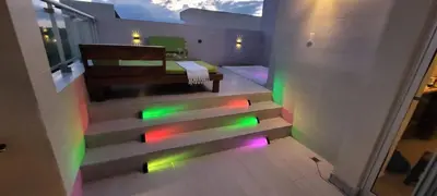 a staircase with colorful lights in a room at Vibe Residence Gorgeous Penthouse with Jacuzzi & outstanding Sea & Natural Preserve view in La Laguna