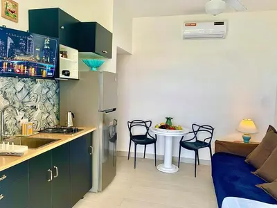 a kitchen with a table and chairs in a room at Vibe Residence Gorgeous Penthouse with Jacuzzi & outstanding Sea & Natural Preserve view in La Laguna