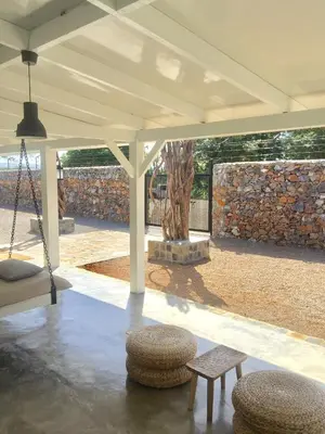 a pavilion with two benches and a stone wall at The Bliss of JAVO BEACH in Las Galeras
