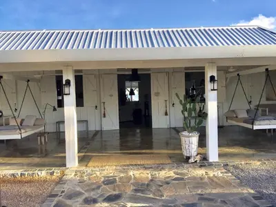 a white pavilion with two beds and a potted plant at The Bliss of JAVO BEACH in Las Galeras