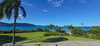 a park with a bench and a view of the ocean at The Bliss of JAVO BEACH in Las Galeras