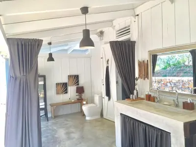 a bathroom with a sink and a toilet and a window at The Bliss of JAVO BEACH in Las Galeras