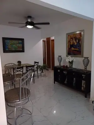 a living room with a ceiling fan and a table and chairs at Residencial Génesis III in Colorado