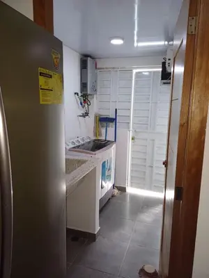 a kitchen with a refrigerator and a sink and a stove at Residencial Génesis III in Colorado