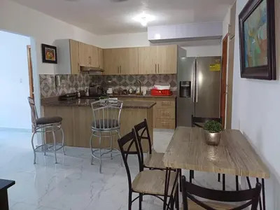 a kitchen with a table and chairs and a refrigerator at Residencial Génesis III in Colorado