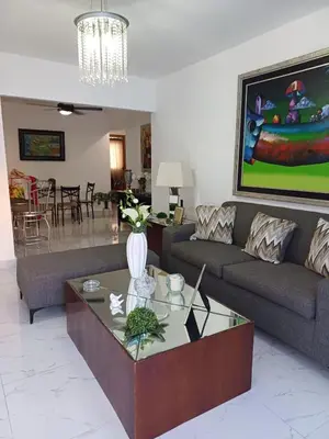 a living room with a couch and a table at Residencial Génesis III in Colorado