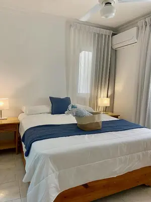 a bedroom with a large bed with a basket on it at Villas Princesa Beach Apartments in Punta Cana