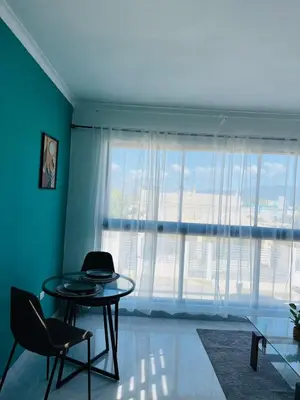a room with a table and a large window at Acogedor apartamento in Colorado