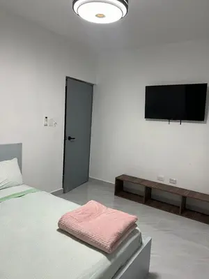 a bedroom with a bed and a flat screen tv at Acogedor apartamento in Colorado