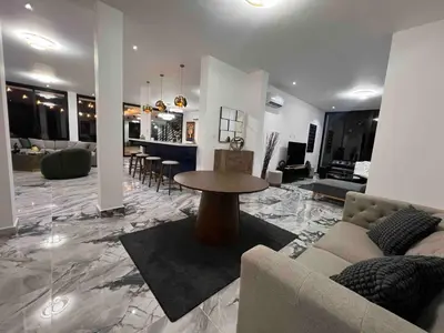a living room with a couch and a table at Elegant, Modern style Villa in Playa Nueva Romana2 in Boca del Soco