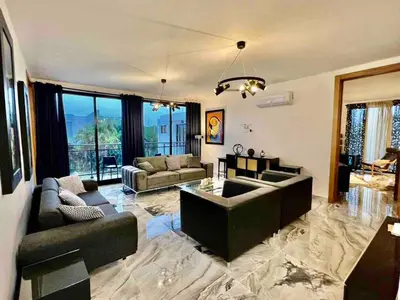 a large living room with couches and a table at Elegant, Modern style Villa in Playa Nueva Romana2 in Boca del Soco