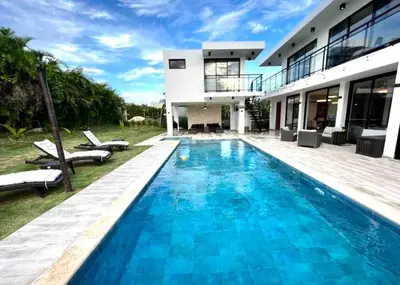 a swimming pool in front of a house at Elegant, Modern style Villa in Playa Nueva Romana2 in Boca del Soco