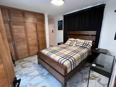 a bedroom with a bed and a glass table at Elegant, Modern style Villa in Playa Nueva Romana2 in Boca del Soco