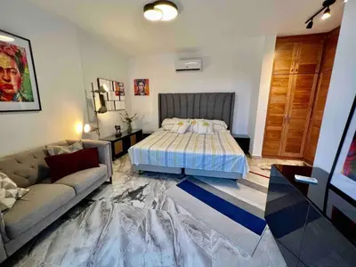 a living room with a bed and a couch at Elegant, Modern style Villa in Playa Nueva Romana2 in Boca del Soco