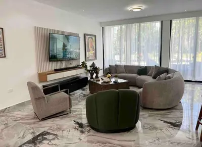 a large living room with a couch and chairs at Elegant, Modern style Villa in Playa Nueva Romana2 in Boca del Soco