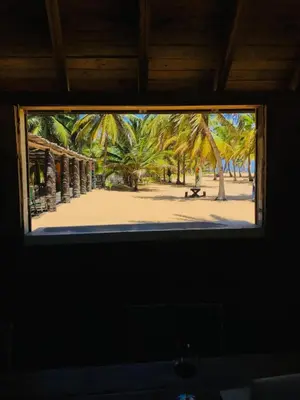 a view from a window of a beach with palm trees at Punta Cana Ecolodge In front of the beach Lavacama Costa Arrecife by BTC Crypto Group in El Eslabón