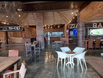 a restaurant with white chairs and a table and tables at Punta Cana Ecolodge In front of the beach Lavacama Costa Arrecife by BTC Crypto Group in El Eslabón