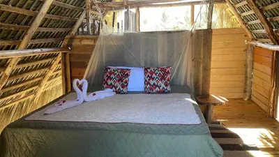 a bedroom with a bed in a tent at Punta Cana Ecolodge In front of the beach Lavacama Costa Arrecife by BTC Crypto Group in El Eslabón