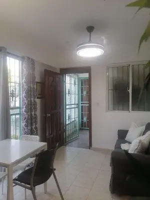a living room with a couch and a table at Tu espacio en zona colonial in Santo Domingo