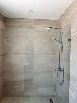 a shower with a glass door in a bathroom at Depto entero, Coral Village D204, WIFI, TV, cerca de la playa in Punta Cana