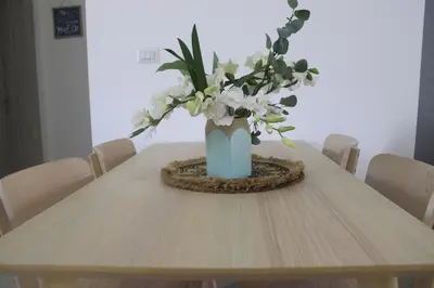 a vase with white flowers sitting on a table at Depto entero, Coral Village D204, WIFI, TV, cerca de la playa in Punta Cana