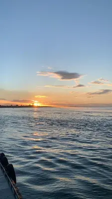 a boat on a body of water with a sunset at ATV Camping in Punta Cana in Punta Cana
