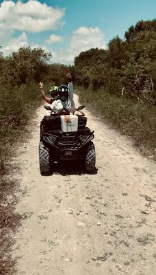 two people on a four wheeler on a dirt road at ATV Camping in Punta Cana in Punta Cana