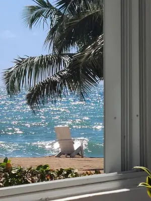 a view of the ocean from a window of a beach at Vista paraiso in La Puntica de Juan Dolio