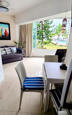 a living room with a table and chairs and a couch at Vista paraiso in La Puntica de Juan Dolio