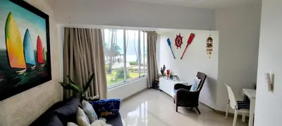 a living room with a couch and a table and a window at Vista paraiso in La Puntica de Juan Dolio