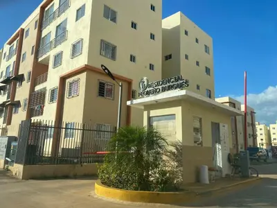 a building with a sign on the front of it at 1st floor 3 Bedrm 2 Baths AC Condo near airport in Los Paredones