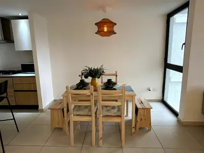 a dining room table with chairs and a vase on it at Comfortable Central Apartment in Santo Domingo