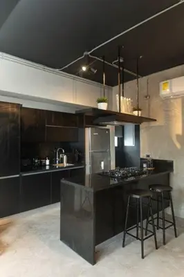 a kitchen with black cabinets and bar stools at PH Loft, 3floors,Private Jacuzzi n terrace,Kingbed in Santo Domingo