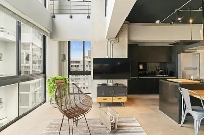 a living room with a large window and a kitchen at PH Loft, 3floors,Private Jacuzzi n terrace,Kingbed in Santo Domingo