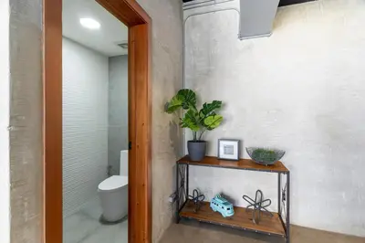 a bathroom with a toilet and a plant on a table at PH Loft, 3floors,Private Jacuzzi n terrace,Kingbed in Santo Domingo