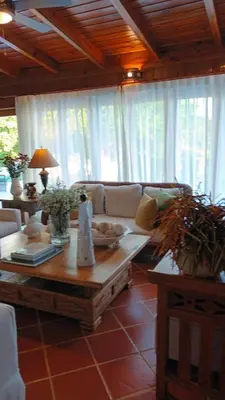 a living room with a couch and a table at Casa de Campo Tenis Villa 16 in La Romana