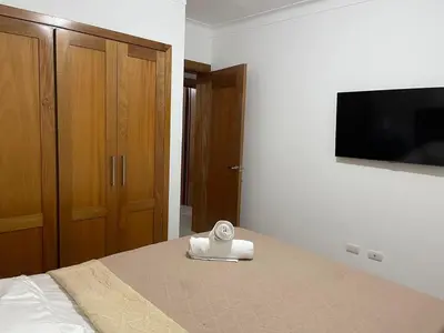 a bedroom with a bed with a towel on it at Modern Apt in Santiago w Pool, 3 Bedrooms, Air conditioner in Santiago de los Caballeros