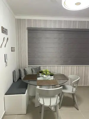 a dining room with a table and chairs and a couch at Modern Apt in Santiago w Pool, 3 Bedrooms, Air conditioner in Santiago de los Caballeros