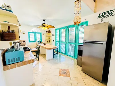 a kitchen with a refrigerator and a table at La Dolce Vita in Las Terrenas