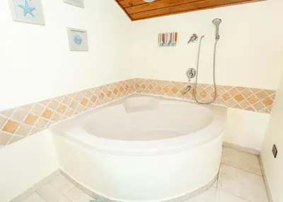 a white toilet in a bathroom with a shower at La Dolce Vita in Las Terrenas