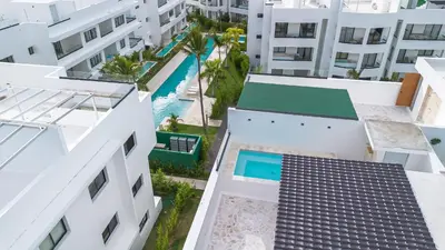 an aerial view of buildings and a swimming pool at Penthouse con picuzzi privado y barbacoa en Bávaro in Punta Cana