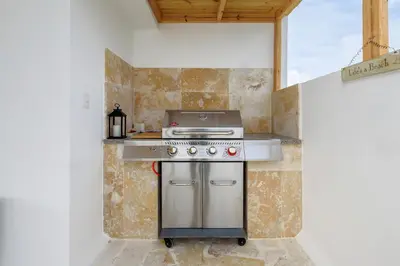 a kitchen with a stainless steel stove in a room at Penthouse con picuzzi privado y barbacoa en Bávaro in Punta Cana