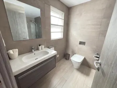 a bathroom with a sink and a toilet at Casa Mulata Paseo del Mar 2 Pool & Playa in Punta Cana